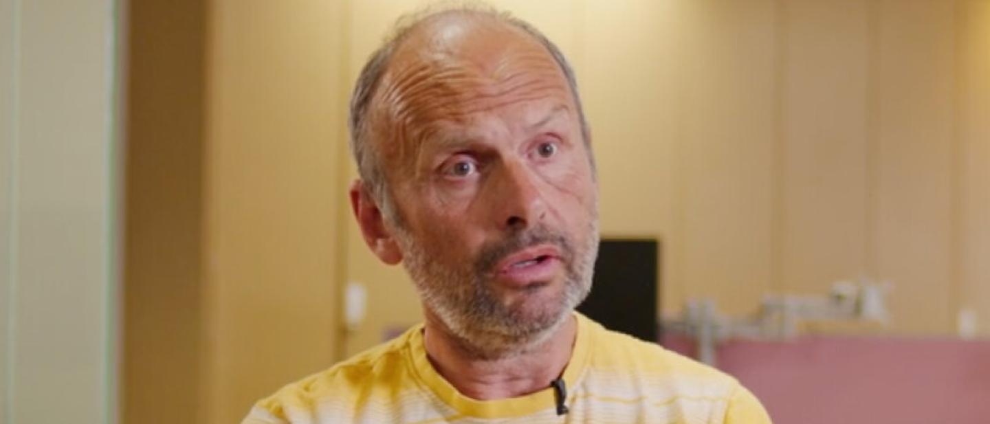 A man in a yellow shirt