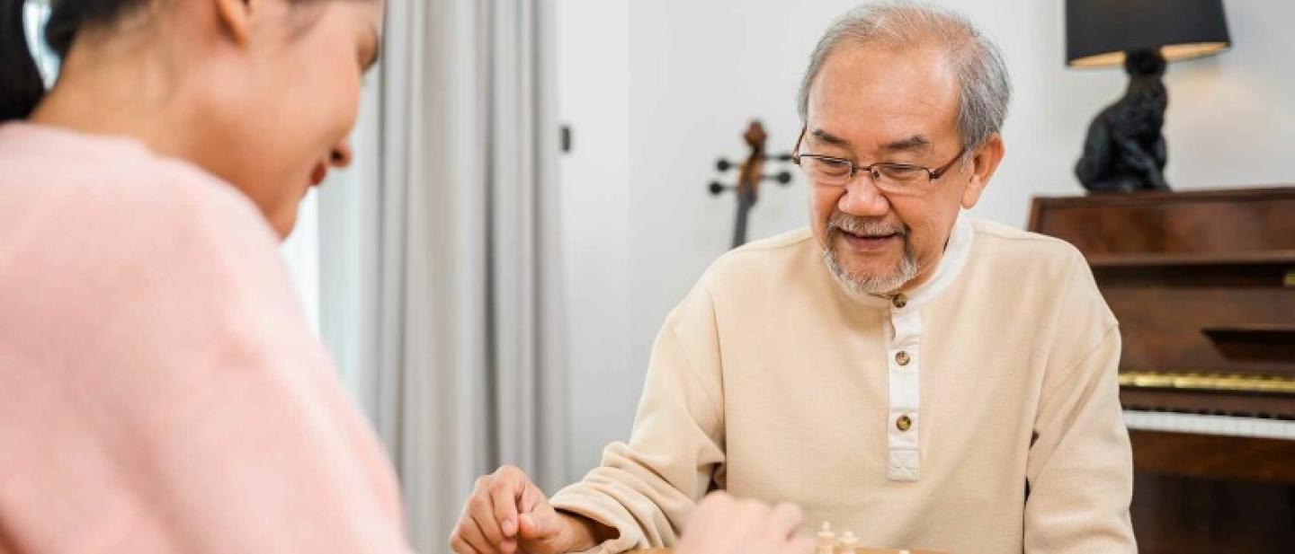 A woman speaking to an elderly man