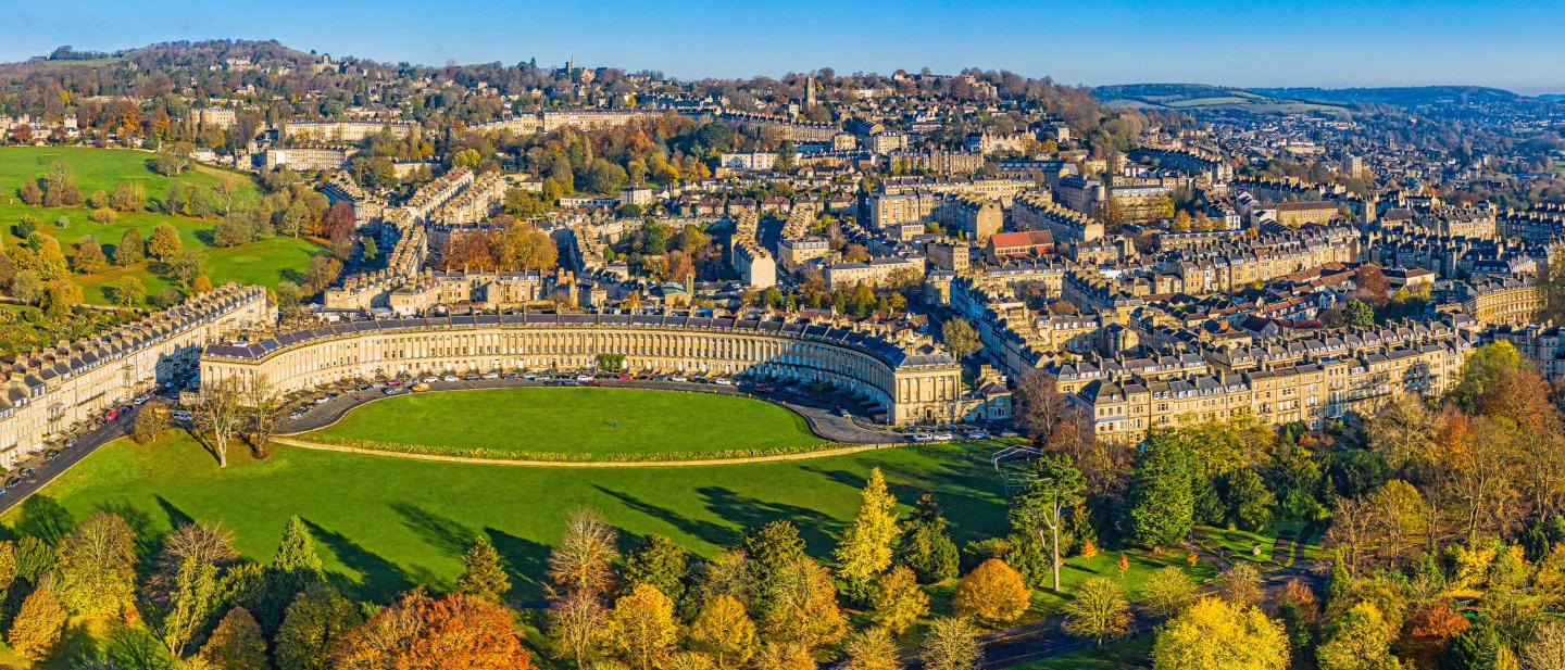 An aerial image of Bath featuring a crescent of Edwardian houses and lots of green space