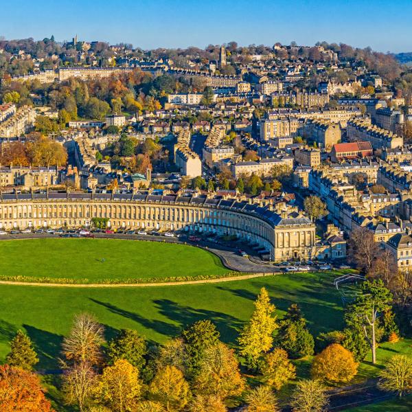 An aerial image of Bath featuring a crescent of Edwardian houses and lots of green space